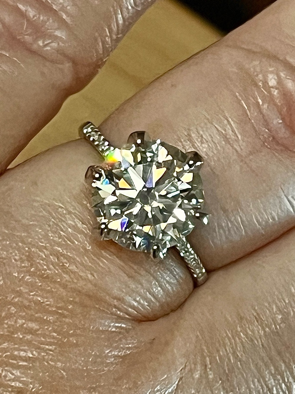 A 5ct Moissanite solitaire with zircon shoulders set in solid